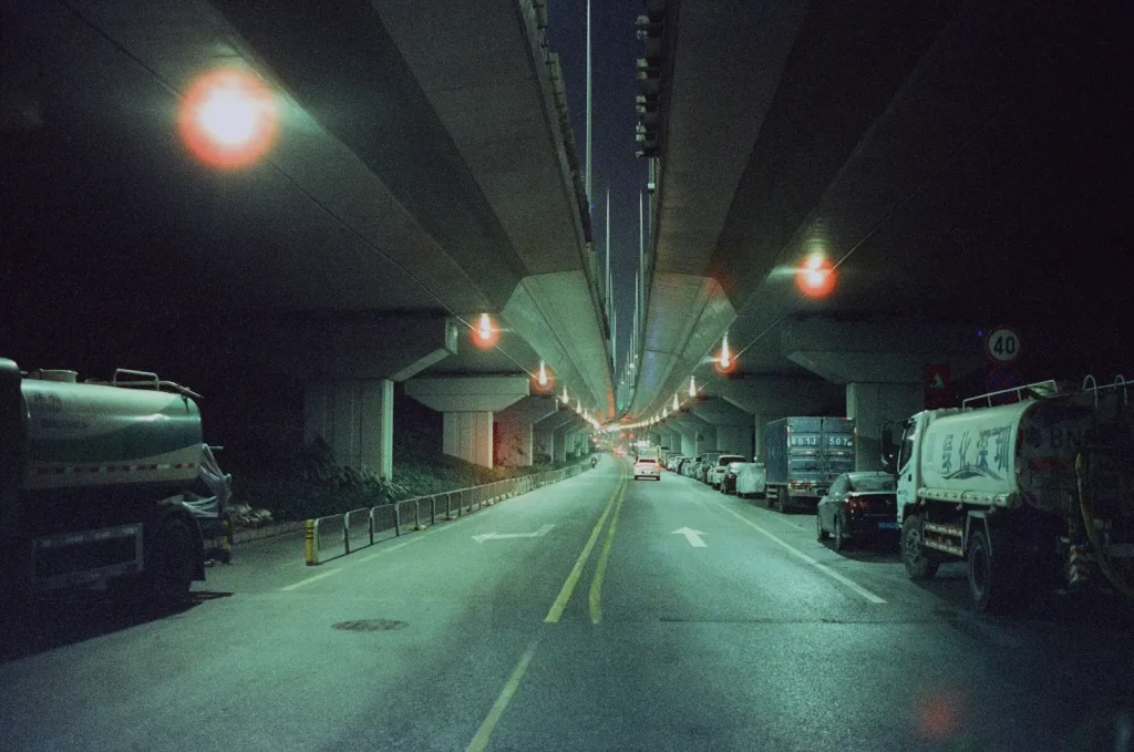 Trucks on an urban road at night